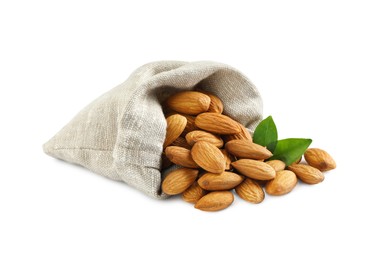 Photo of Sack with organic almond nuts and green leaves on white background. Healthy snack