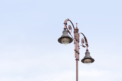 Photo of Beautiful old fashioned street lamps against sky