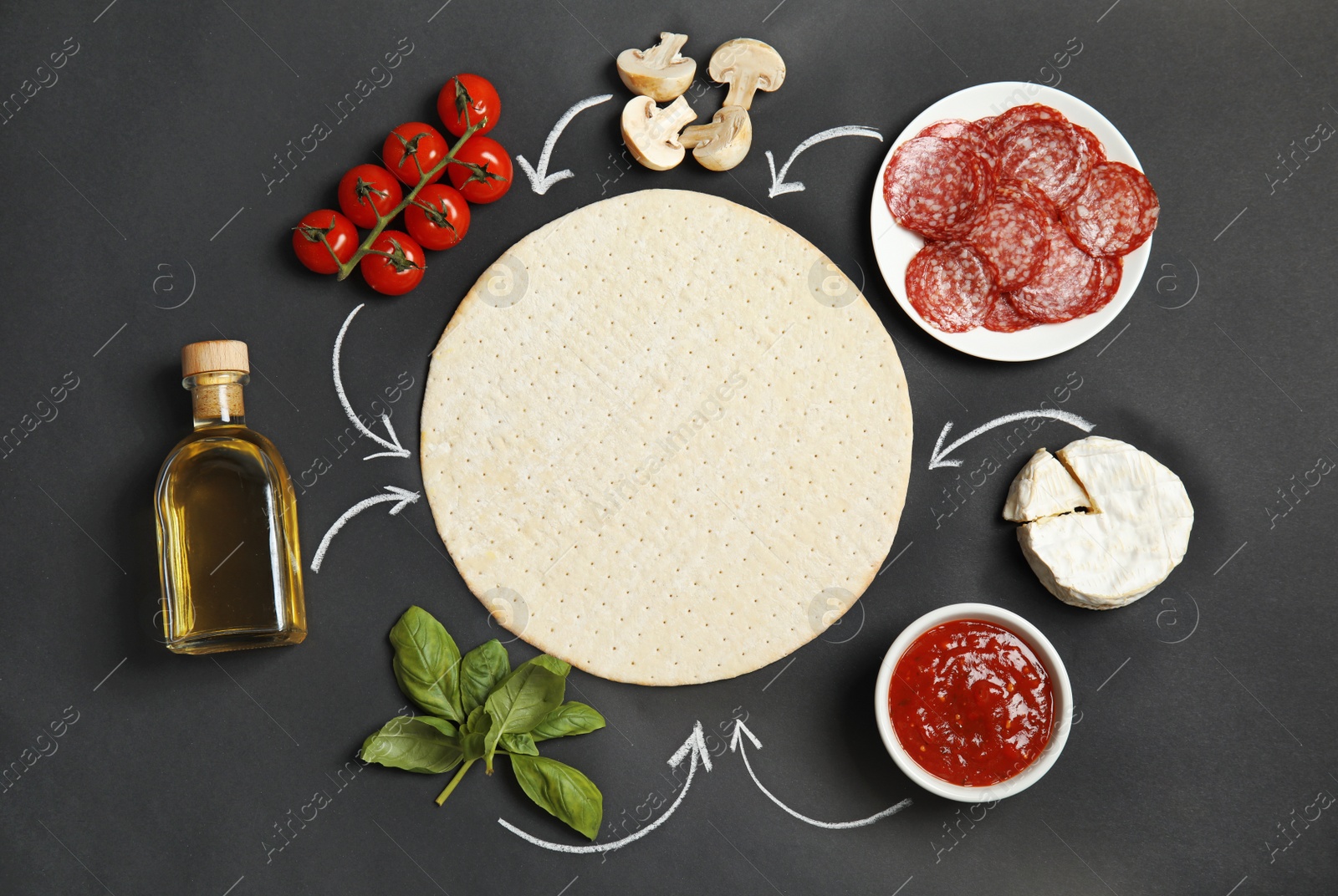 Photo of Flat lay composition with pizza crust and ingredients on black background