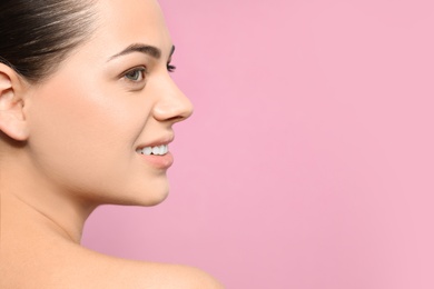 Portrait of young woman with beautiful face and natural makeup on color background, closeup. Space for text