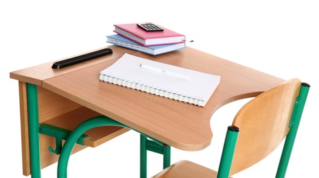 Photo of Wooden school desk with stationery on white background