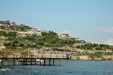 Photo of Picturesque view of sea and pier under blue sky