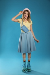 Photo of Young woman with retro roller skates on color background