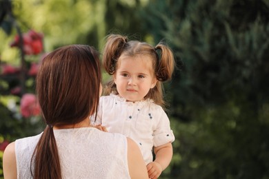 Photo of Mother with her cute daughter spending time together outdoors