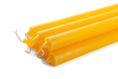 Photo of Many church wax candles on white background, closeup