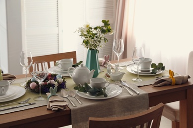 Photo of Beautiful Easter table setting with festive decor indoors