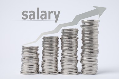 Salary increase concept. Stacked coins and illustration of up arrow on light background