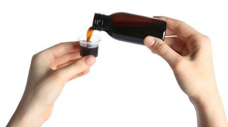 Photo of Woman pouring cough syrup into measuring cup on white background, closeup