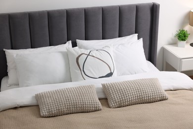 Soft pillows and duvet on bed at home