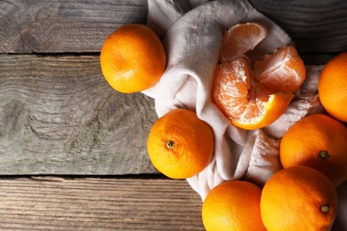 Tasty fresh tangerines on wooden table, flat lay