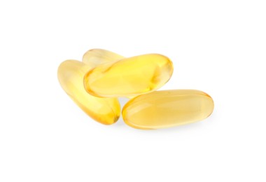 Photo of Many yellow vitamin capsules isolated on white