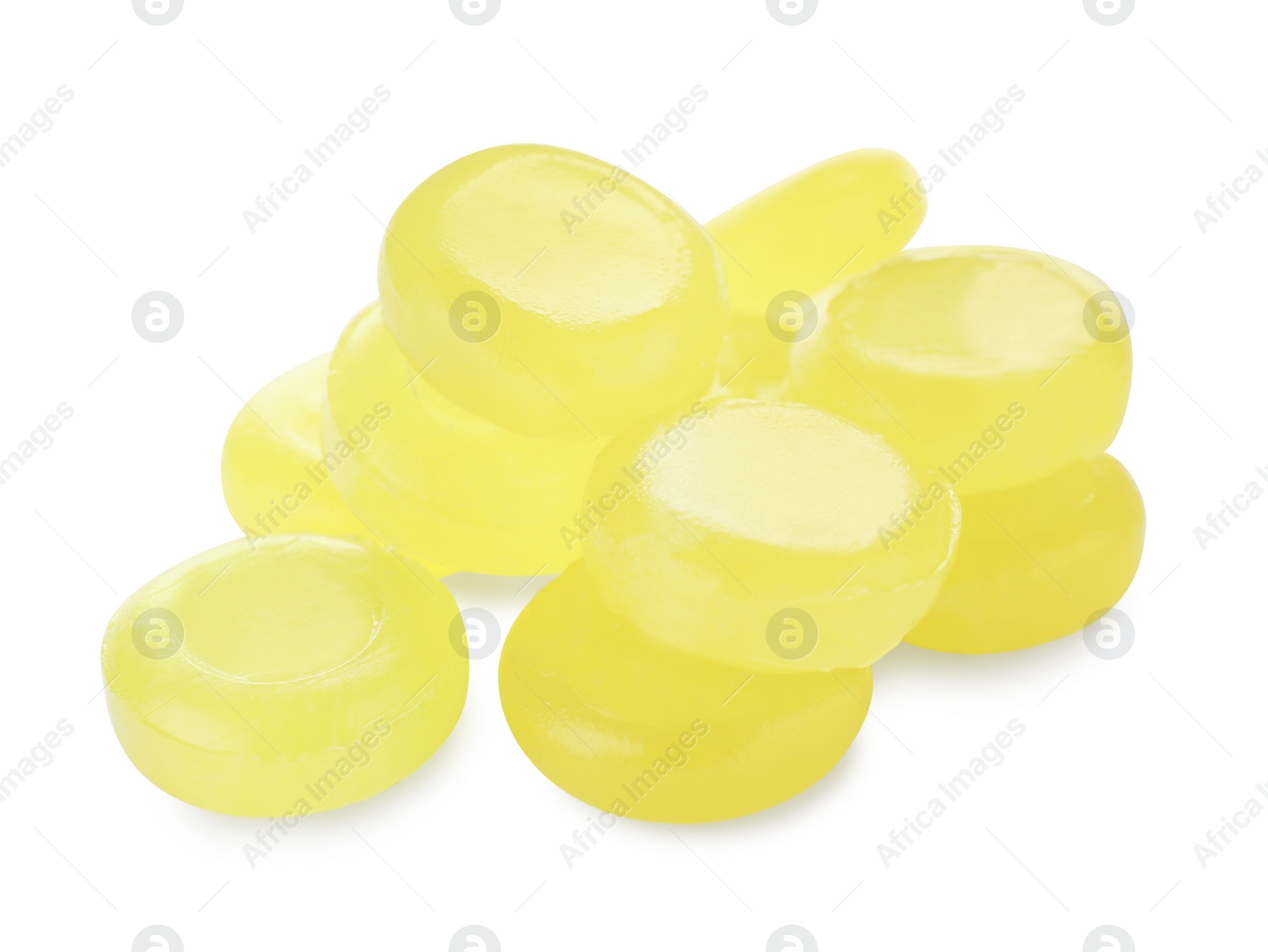 Photo of Many yellow cough drops on white background