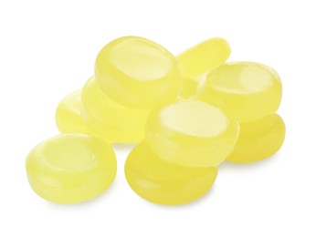 Photo of Many yellow cough drops on white background