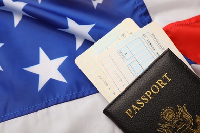 Photo of Passport and tickets on flag of USA, top view