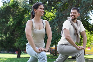 Photo of Man and woman doing morning exercise in park