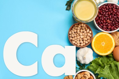 Image of Different fresh products with high amounts of easily absorbable calcium on turquoise background, flat lay