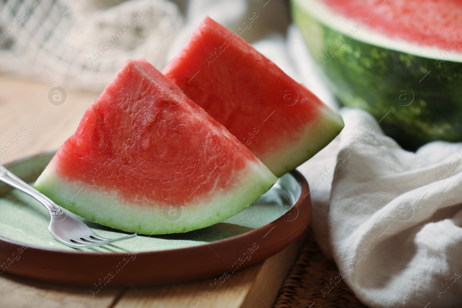 Photo of Sliced fresh juicy watermelon on wooden table, closeup