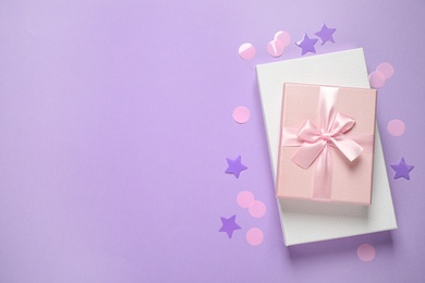 Photo of Beautiful gift boxes and confetti on violet background, flat lay. Space for text