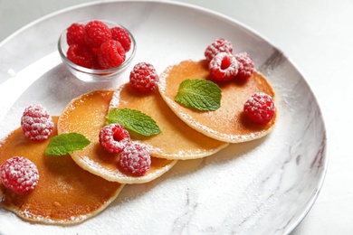 Photo of Tasty pancakes with berries and mint on plate, closeup