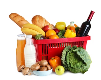 Photo of Shopping basket and grocery products on white background
