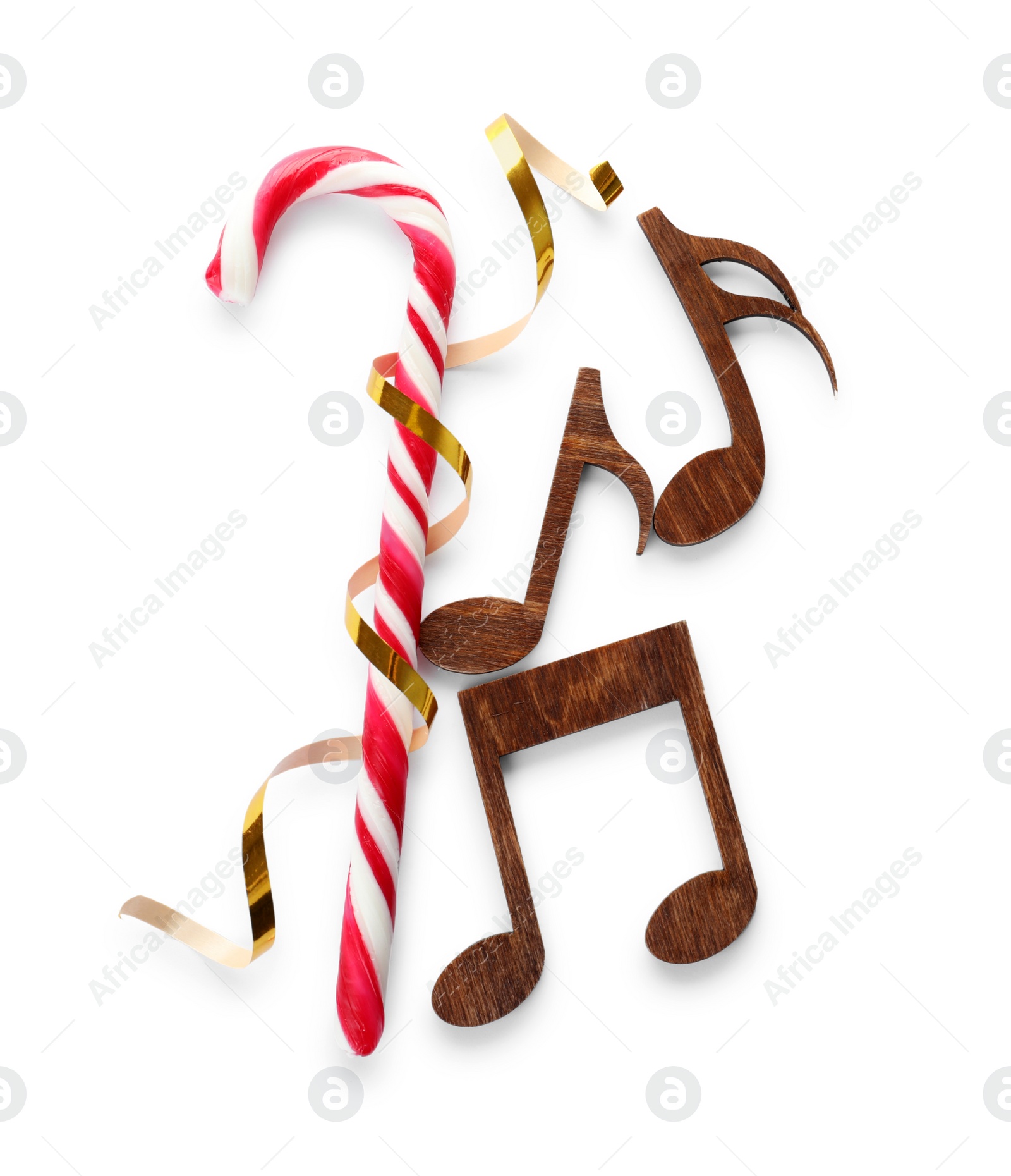 Photo of Composition with wooden music notes and candy cane on white background, top view