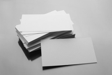 Photo of Blank business cards on mirror surface. Mockup for design