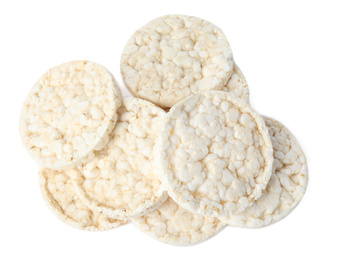 Photo of Pile of crunchy rice cakes isolated on white, top view