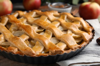 Photo of Delicious traditional apple pie on wooden table, closeup