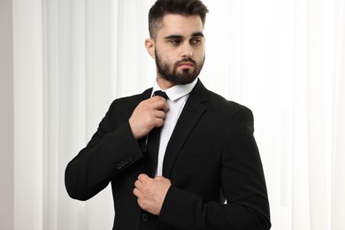 Photo of Handsome businessman in suit and necktie indoors