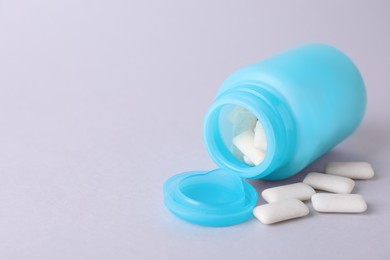Photo of Jar with chewing gums on light grey background