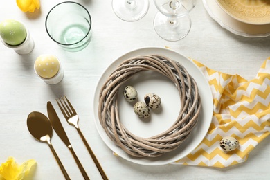 Photo of Festive Easter table setting with eggs on wooden background, top view