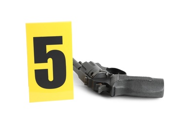 Photo of Gun and crime scene marker with number five isolated on white