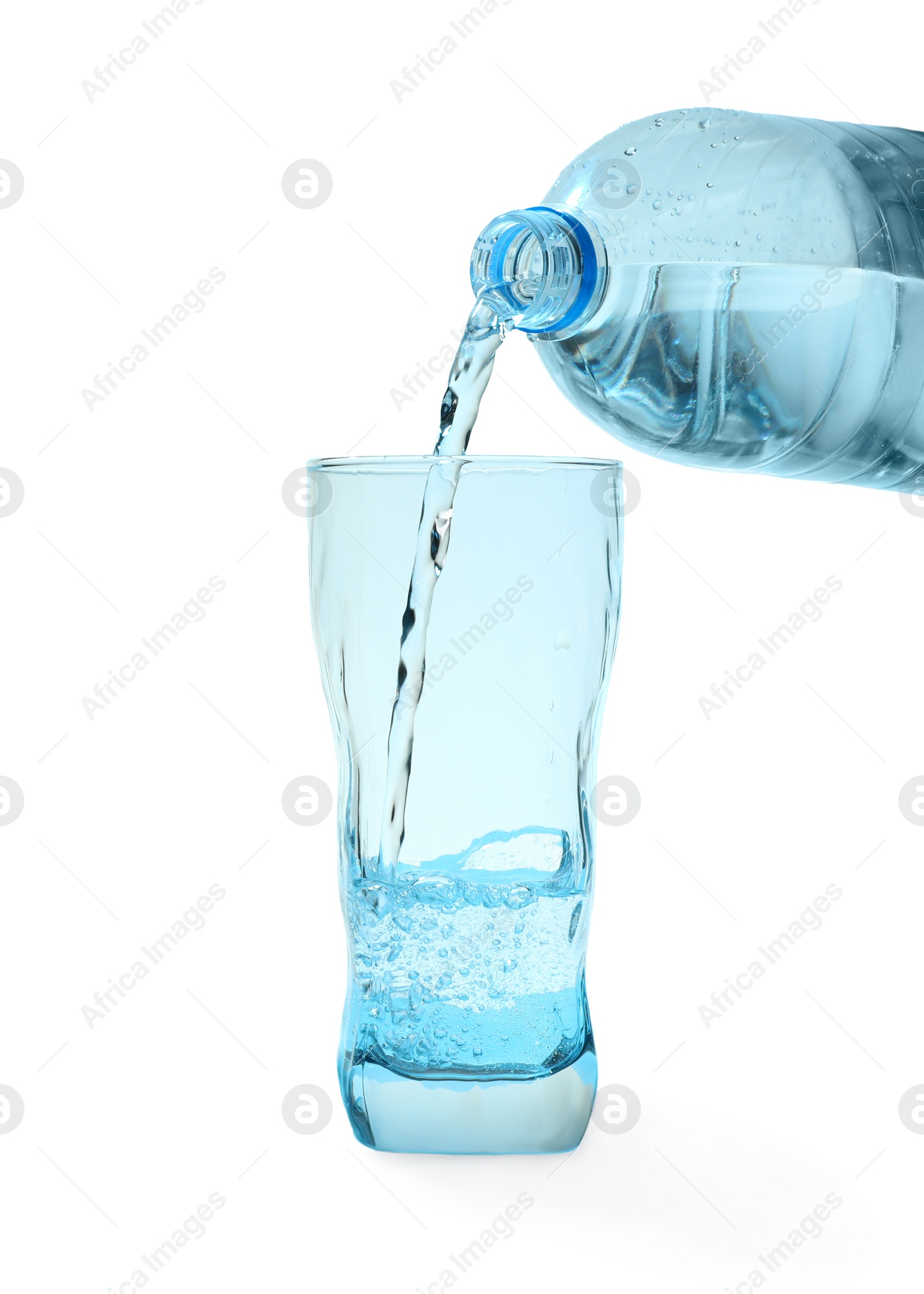 Photo of Pouring water from bottle into glass against blue background. Refreshing drink