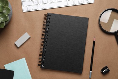 Flat lay composition with stylish notebook on brown background