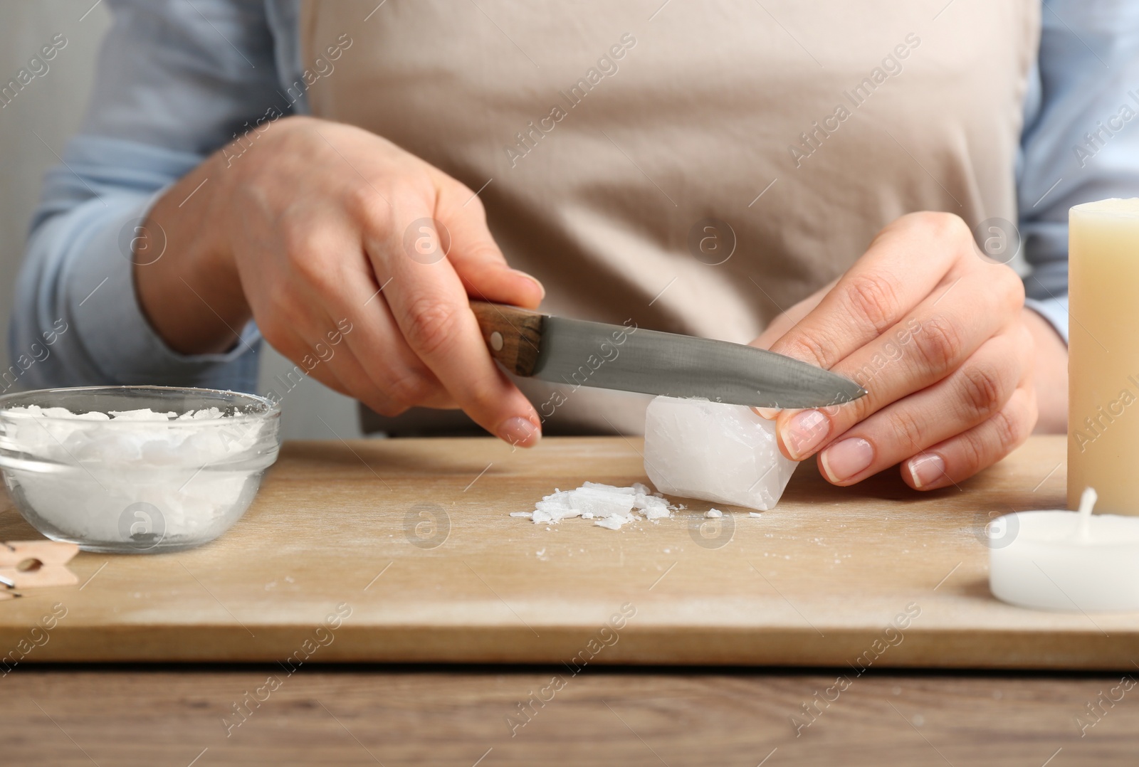 Photo of Woman making decorative aroma candle at table, closeup