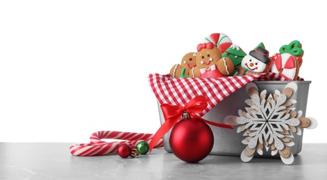 Photo of Tasty Christmas cookies on light table against white background