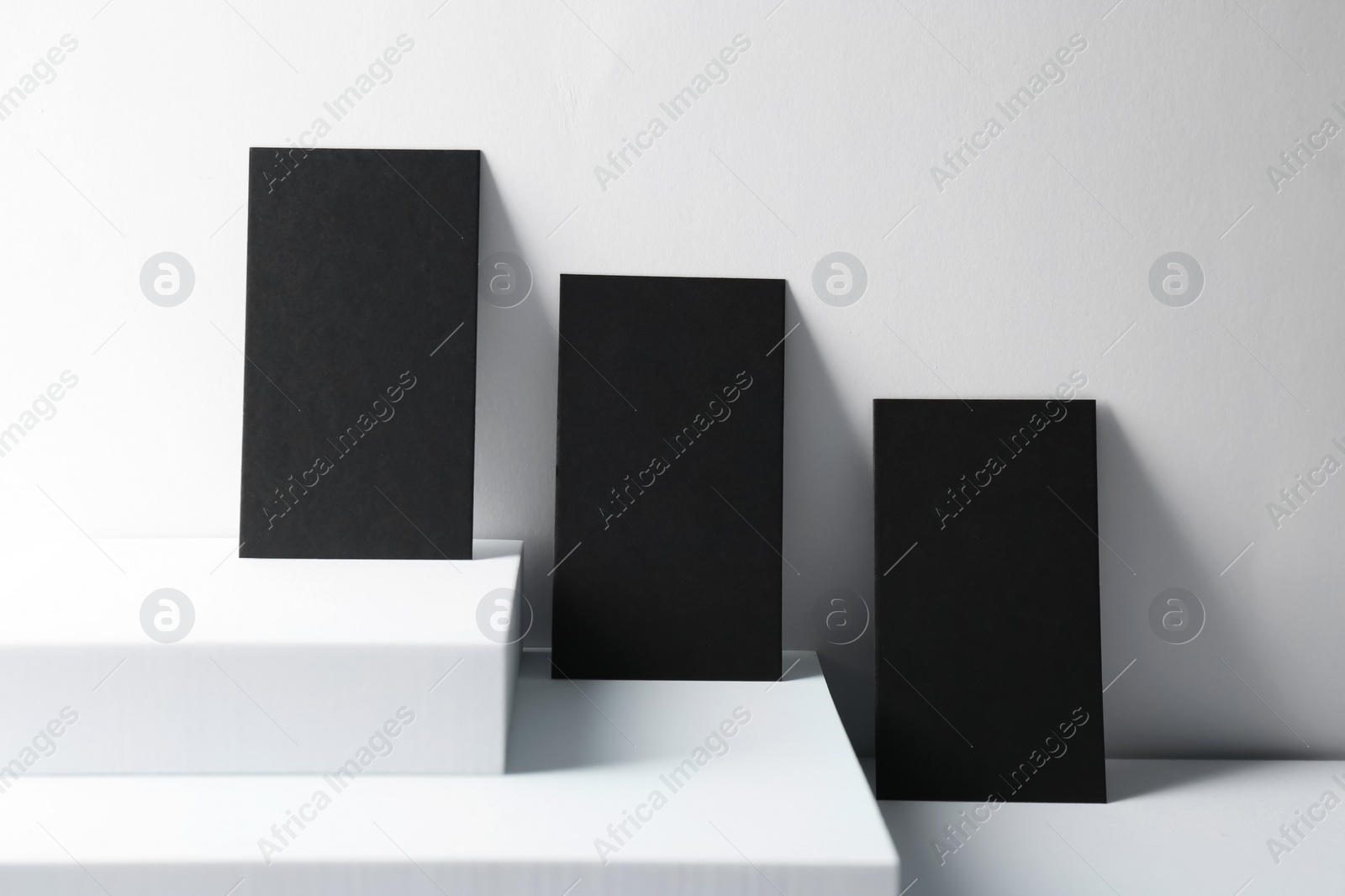 Photo of Blank black business cards on white background. Mockup for design