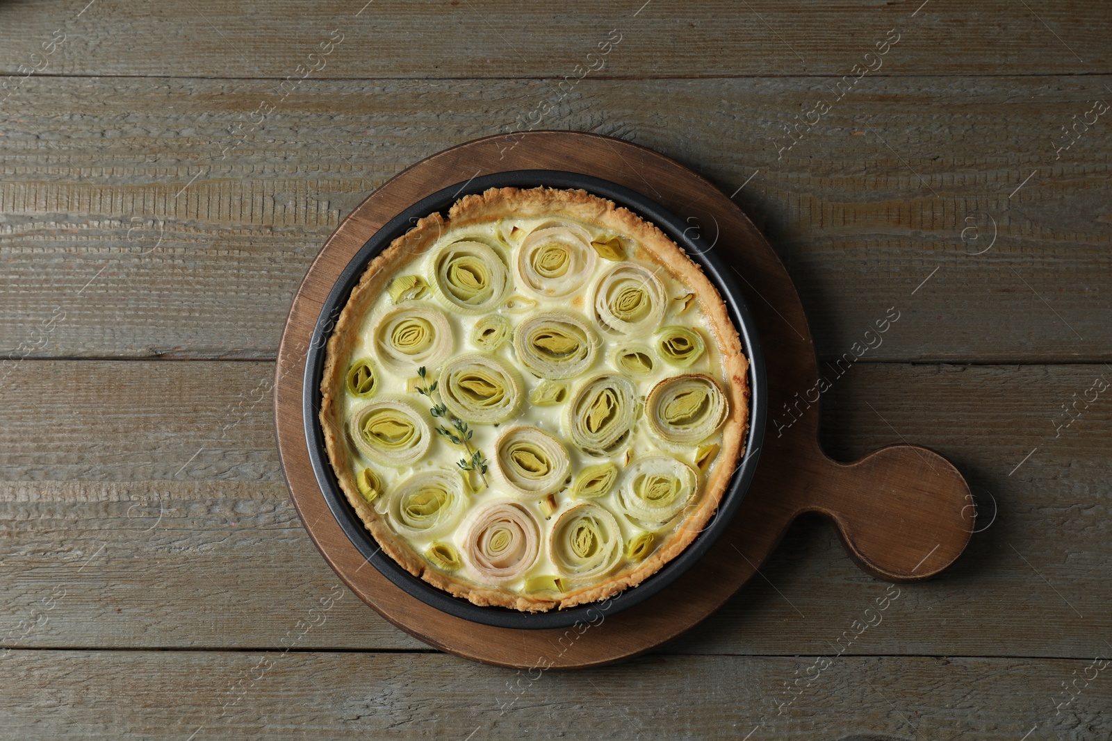 Photo of Tasty leek pie on wooden table, top view