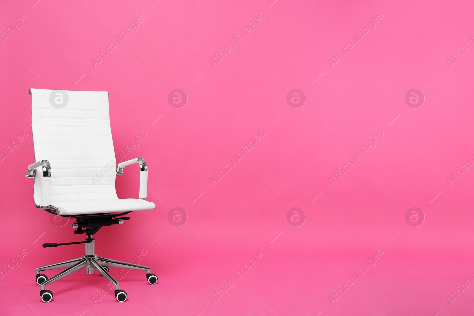 Photo of Comfortable office chair on pink background, space for text