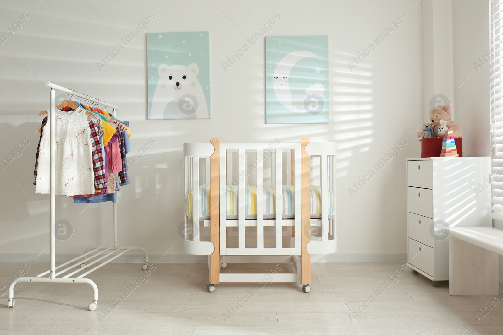 Photo of Different clothes hanging on rack in bedroom