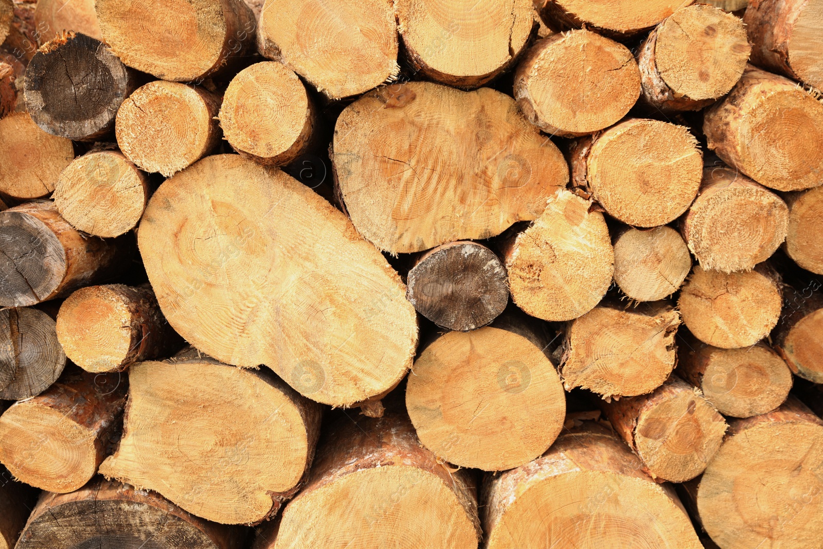 Photo of Stacked firewood as background, closeup. Heating in winter