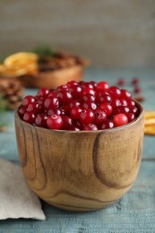 Photo of Fresh ripe cranberries on blue wooden table