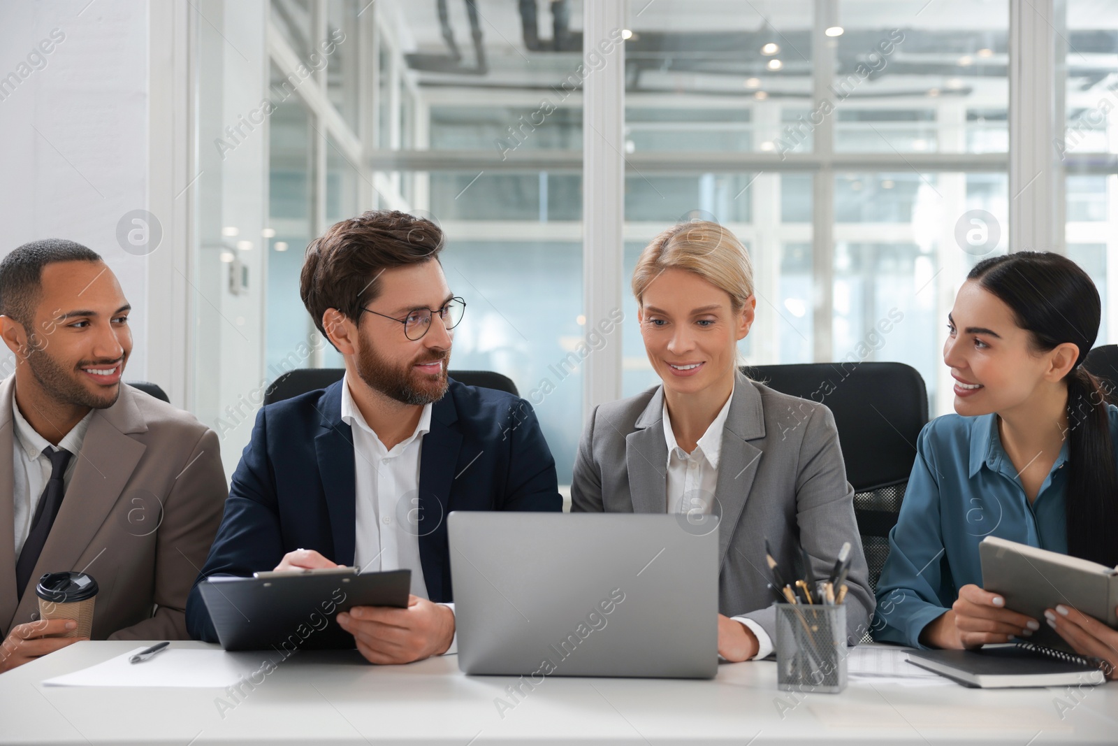 Photo of Lawyers working together with laptop at table in office