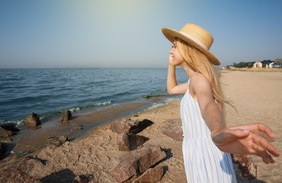Photo of Beautiful young woman with straw hat near sea on sunny day in summer