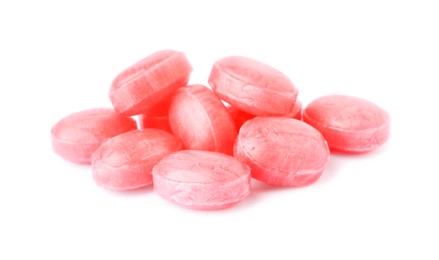 Many pink cough drops on white background