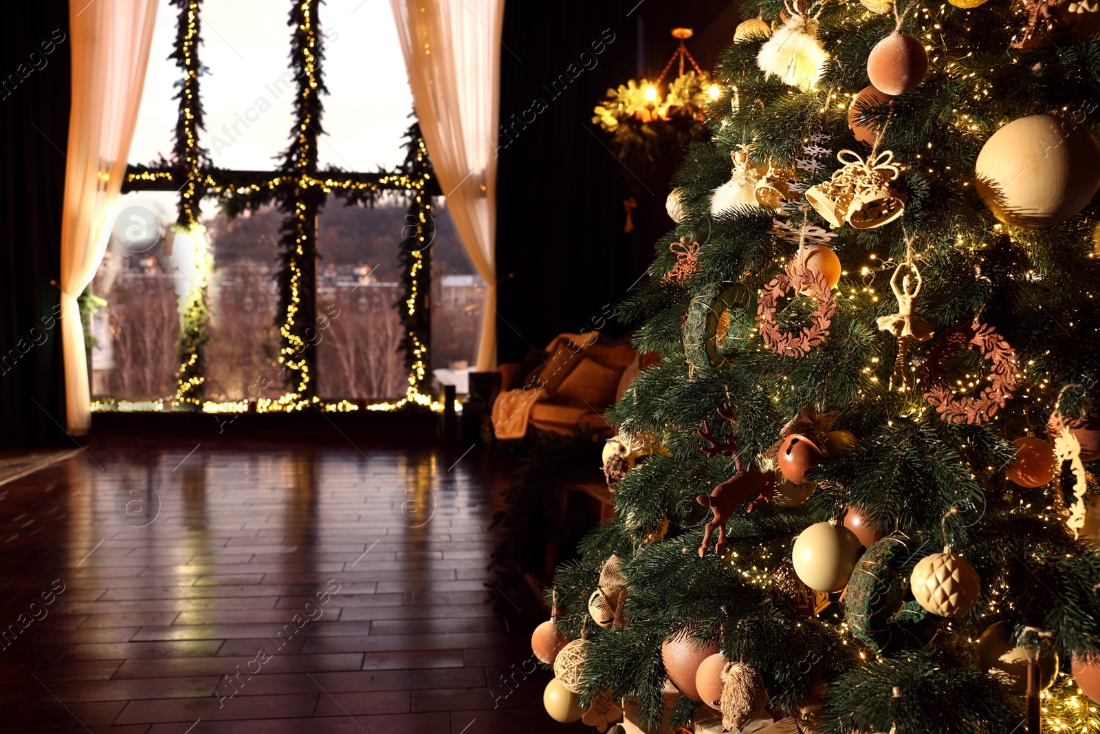 Photo of Beautiful Christmas tree in room with festive decor