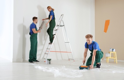 Photo of Professional decorators working indoors. Home repair service