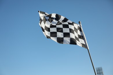 Checkered finish flag on light blue background