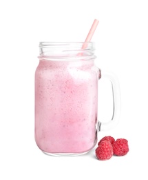 Photo of Tasty raspberry milk shake in mason jar and fresh berries isolated on white