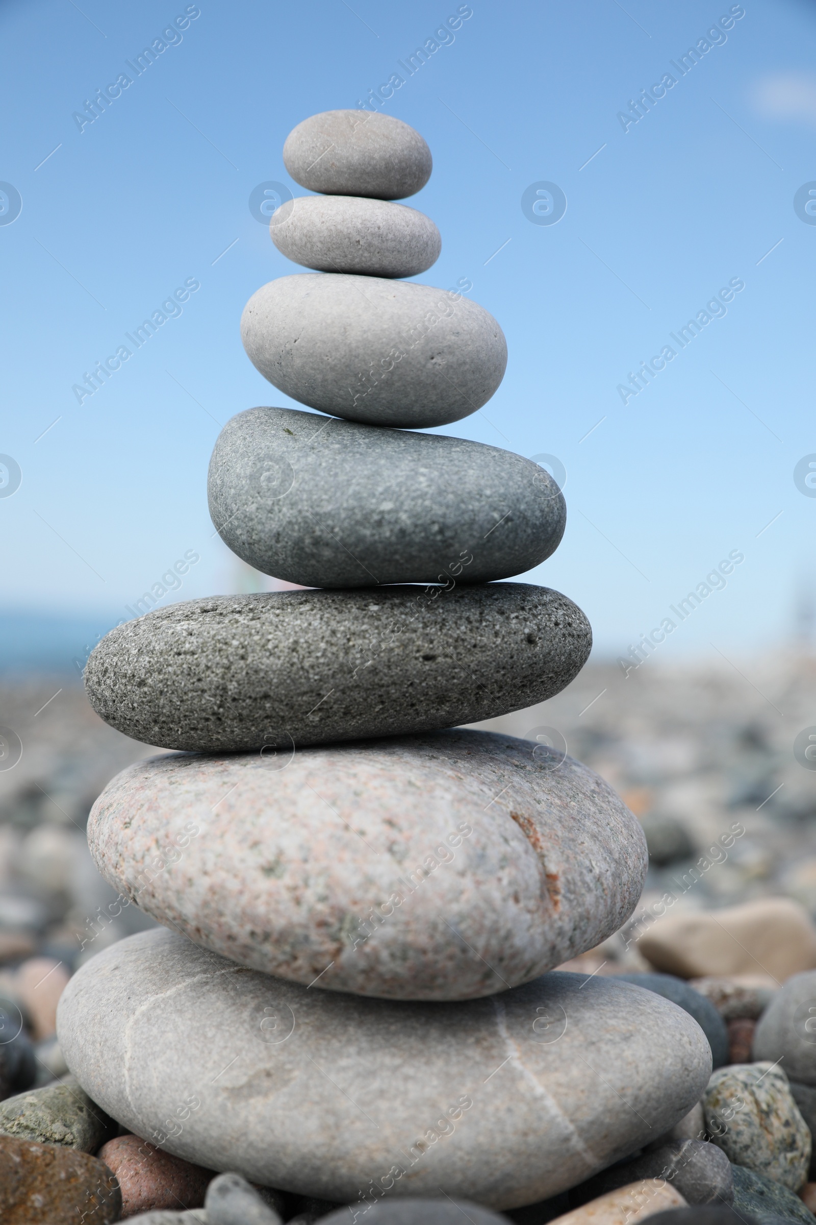 Photo of Stack of stones on beach against blurred background, closeup